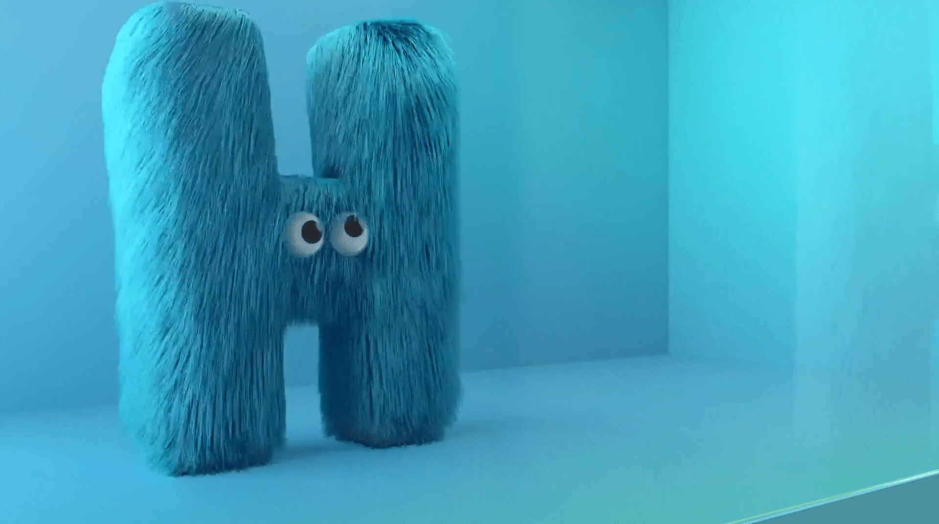 blue fluffy H with googly eyes